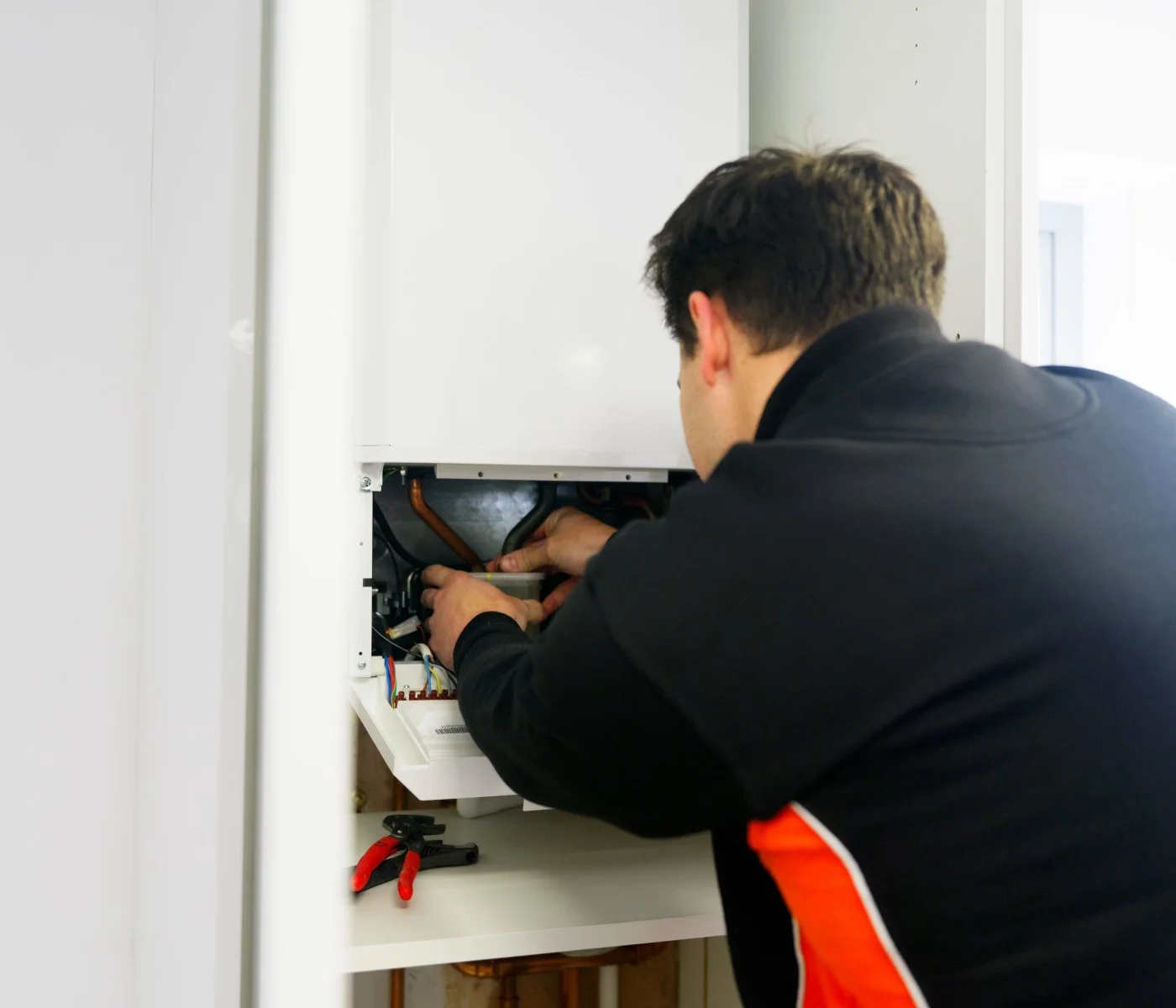 Boiler Engineer Servicing And Repairing A Boiler In A Yorkhire Home By LS1 Plumbing
