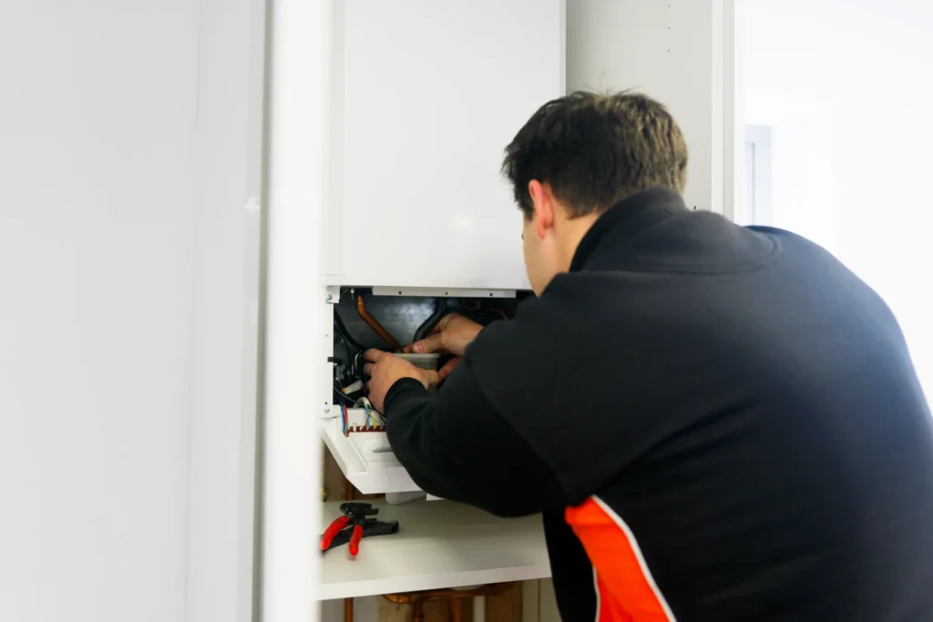 Gas Safe Heating Engineeer completeing a Boiler Repair and Maintenance Completed By LS1 Plumbing